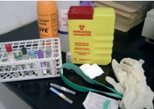 Contenidor rígid, xeringues, agulles d'extracció, banda de goma de compressió, tubs de buit i portatubs en forma de matriu.